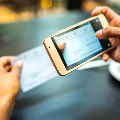 Person depositing checking using phone and mobile app.