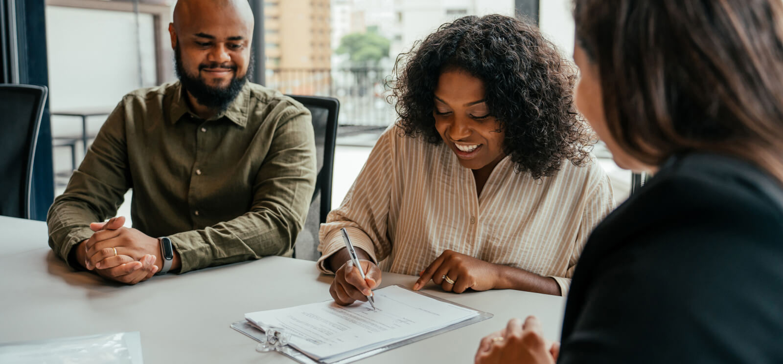 Couple signing financial documents.